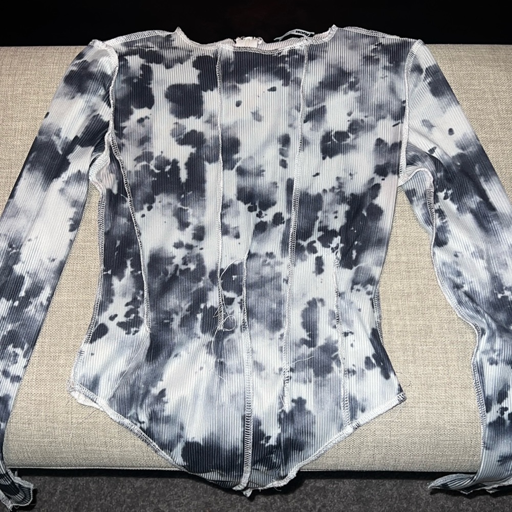 Fashionova Women’s distressed bodysuit with bottom snap closure and back zip.
